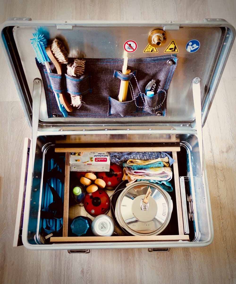 An aluminium case for cooking and cleaning dishes while camping