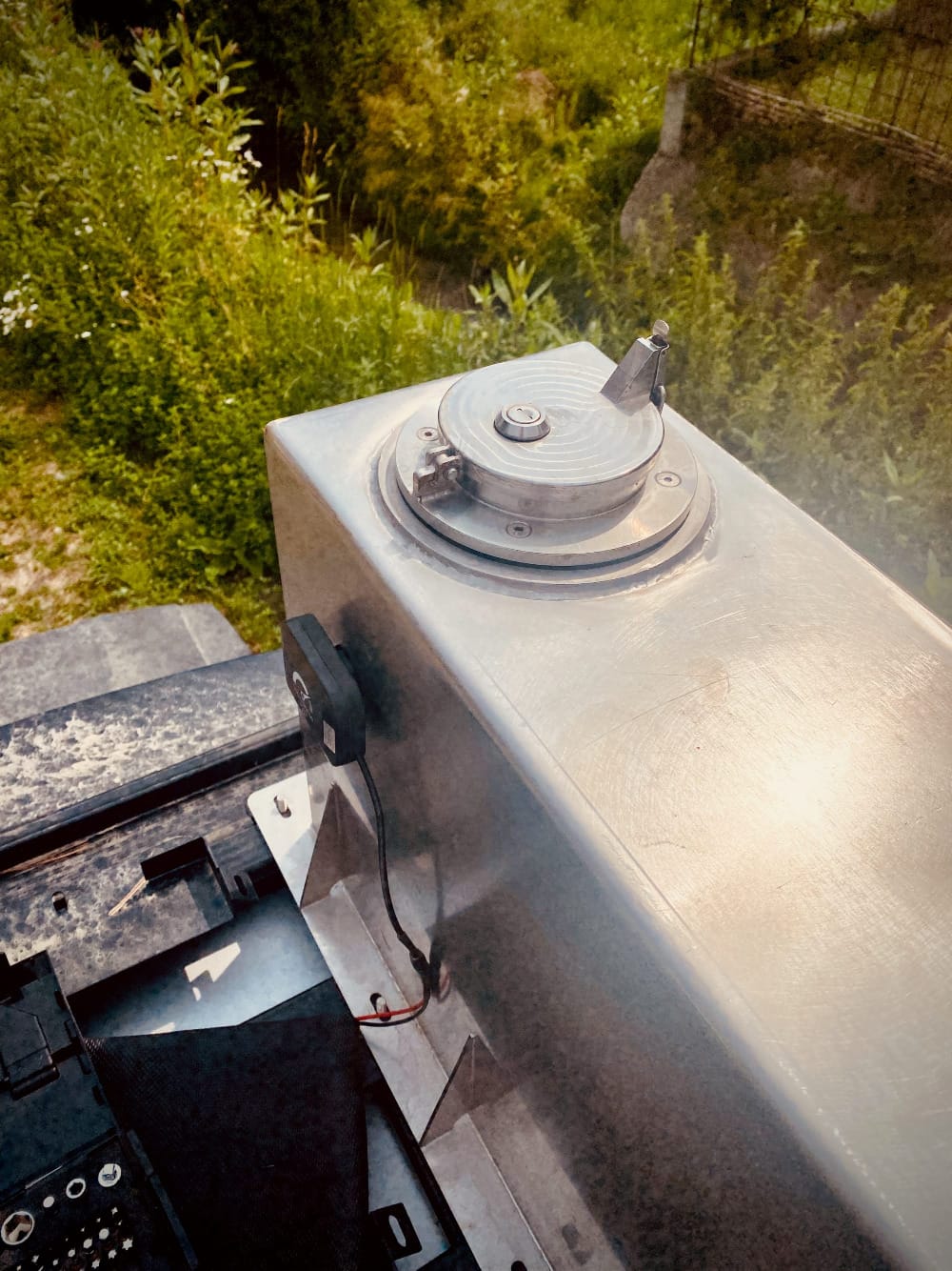 A water tank mounted on the roof rack of a car