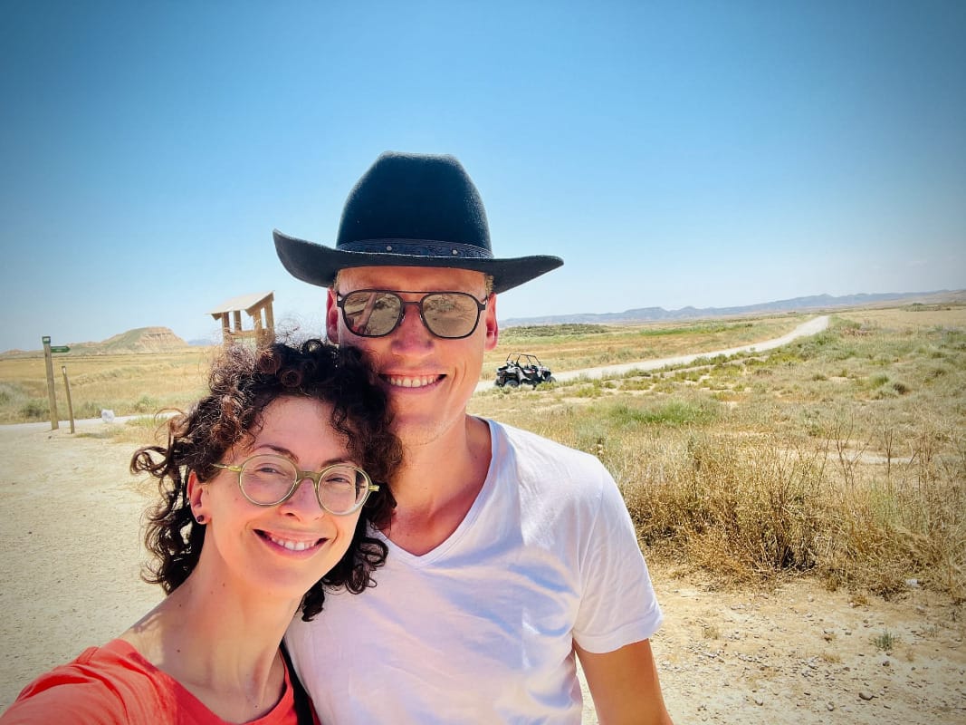 Portrait of Kathrin and Sebastian with the rugged, unique terrain of Bardenas Reales semi-desert in the background.