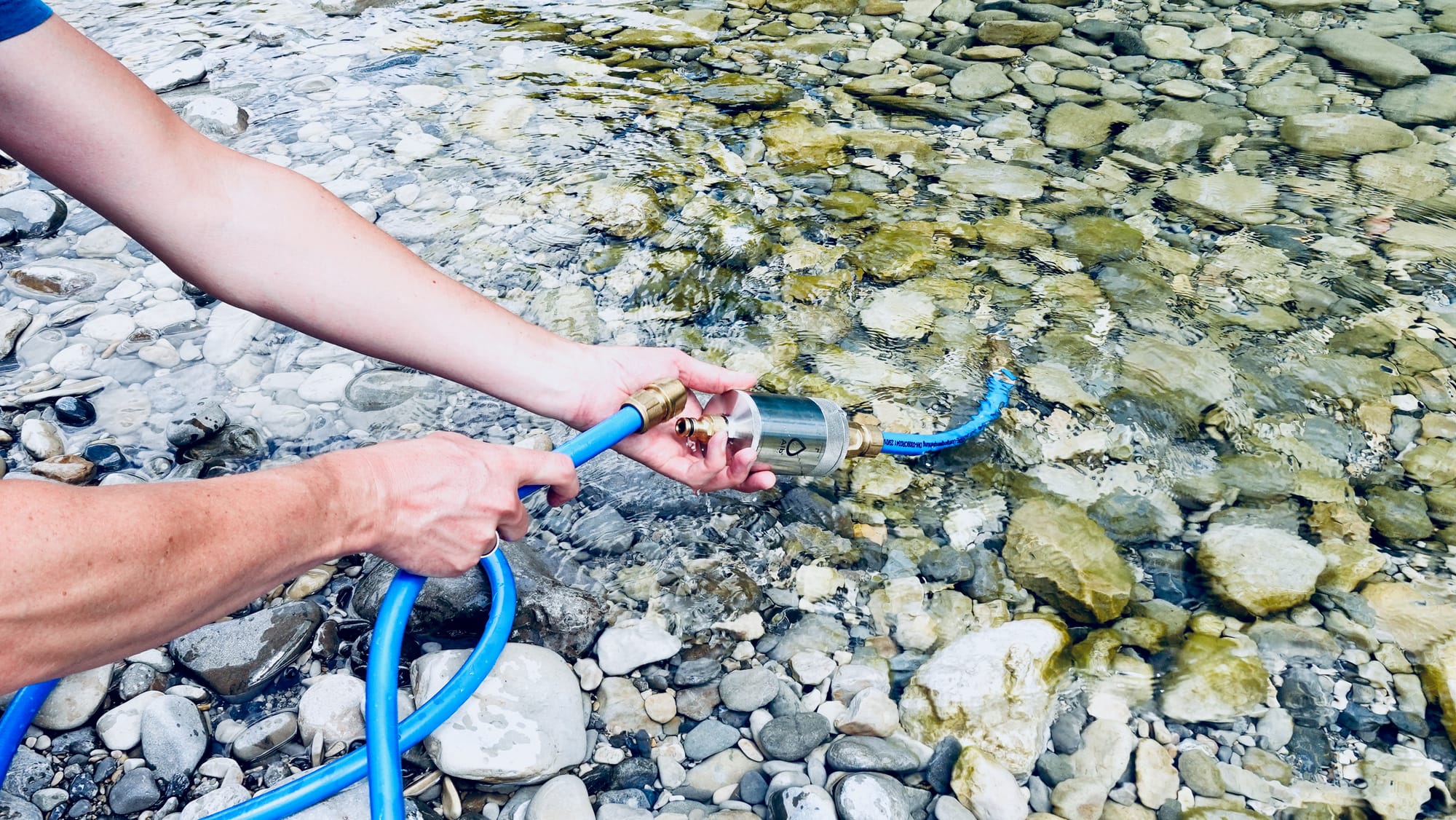 Connecting a filter to a water hose to pump water from a river